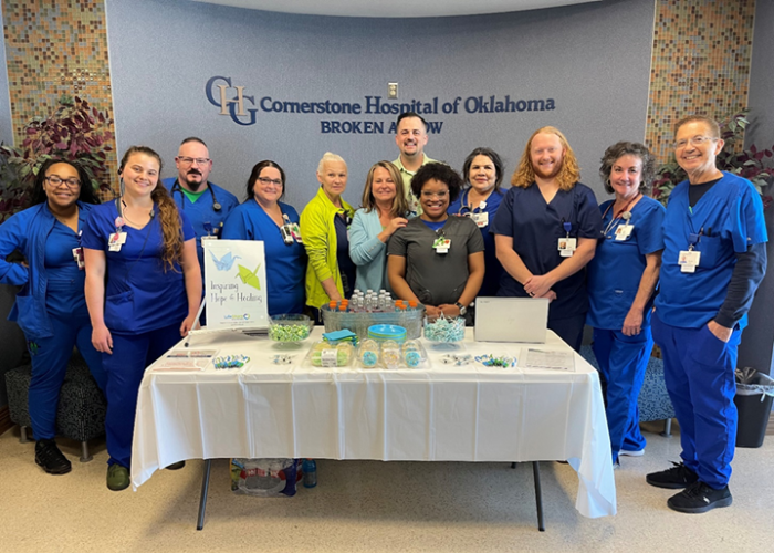 Kyle Pingleton at awards team with Broken Arrow team members